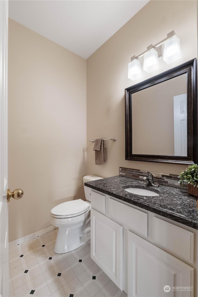 bathroom with vanity, toilet, and tile patterned floors