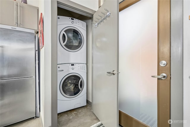 laundry room with stacked washer / drying machine