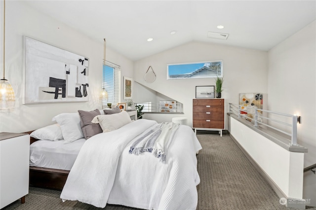 bedroom with vaulted ceiling and dark carpet