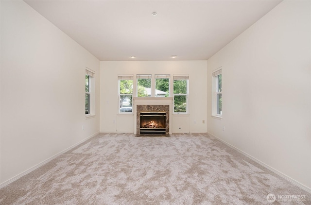 22635 SE 44th Pl Unit 1631, Issaquah, WA 98029 - unfurnished living room featuring a premium fireplace, carpet, and baseboards