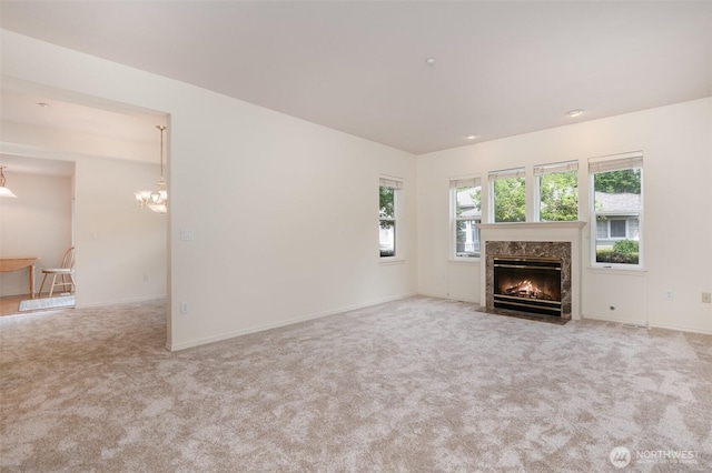 22635 SE 44th Pl Unit 1631, Issaquah, WA 98029 - unfurnished living room with a fireplace, carpet flooring, a chandelier, and baseboards
