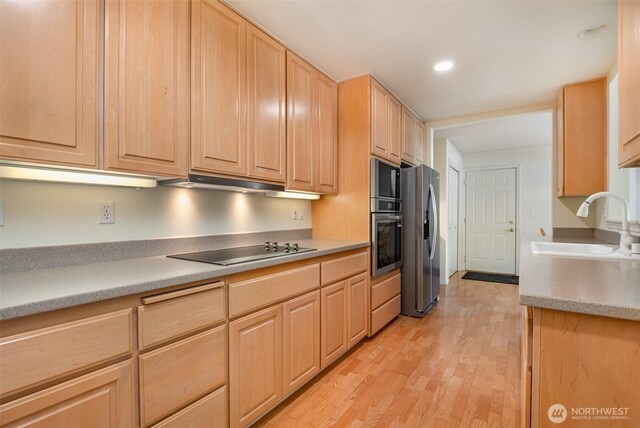 22635 SE 44th Pl Unit 1631, Issaquah, WA 98029 - kitchen featuring light brown cabinetry, stainless steel appliances, a sink, light wood-style flooring, and light countertops
