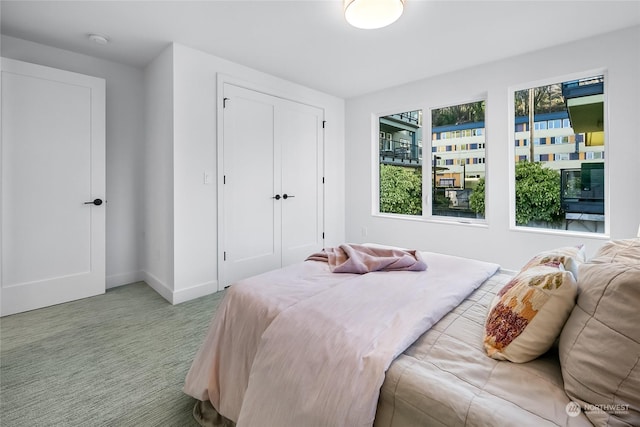 bedroom featuring light carpet and a closet