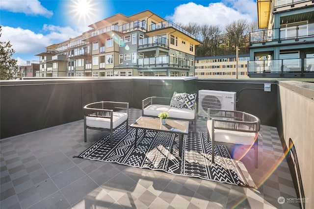 balcony with an outdoor living space and ac unit