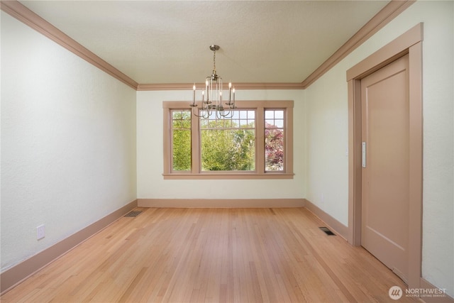 811 N I St, Tacoma, WA 98403 - unfurnished dining area with baseboards, an inviting chandelier, light wood-style floors, and ornamental molding