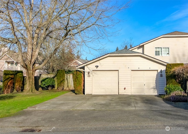 view of front of home featuring a garage and a front lawn