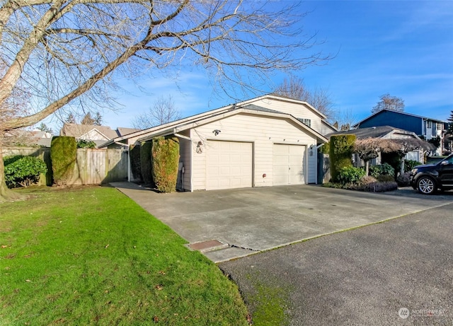 view of home's exterior with a garage and a lawn