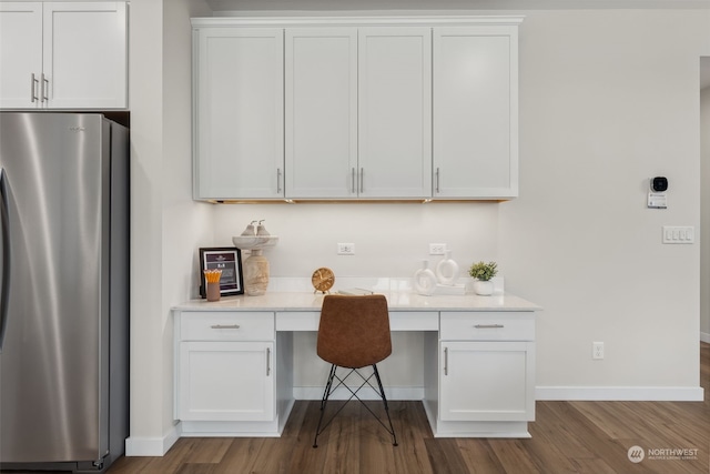 office with built in desk and wood-type flooring