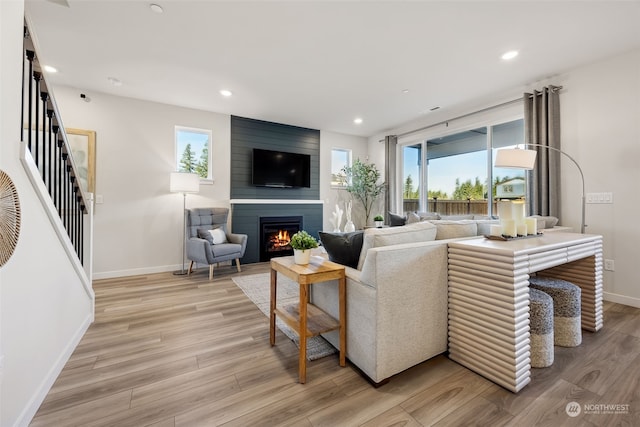 living room with a fireplace and light hardwood / wood-style flooring