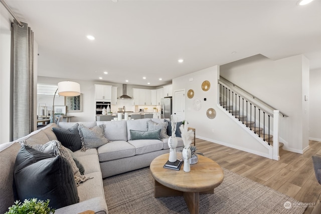 living room with sink and light hardwood / wood-style floors