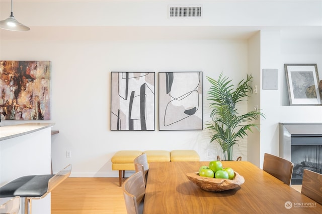 dining space with wood-type flooring