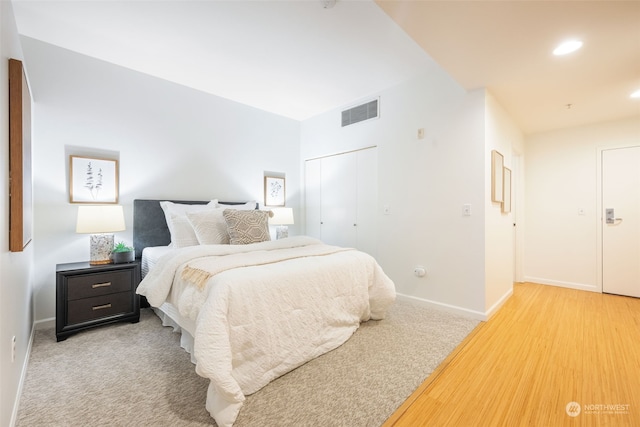 bedroom with light colored carpet and a closet