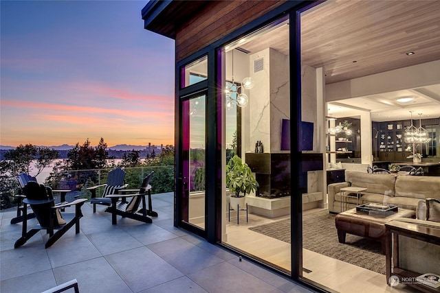 exterior space featuring a chandelier and wood ceiling