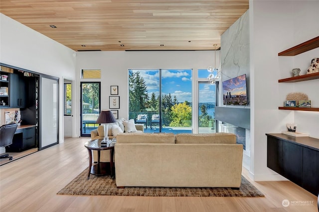 living room with built in desk, wood ceiling, and light hardwood / wood-style flooring