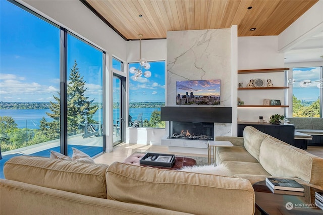 living room with a healthy amount of sunlight, a high end fireplace, and wood ceiling