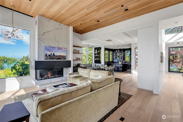 living room featuring wood ceiling, a notable chandelier, and light wood-type flooring