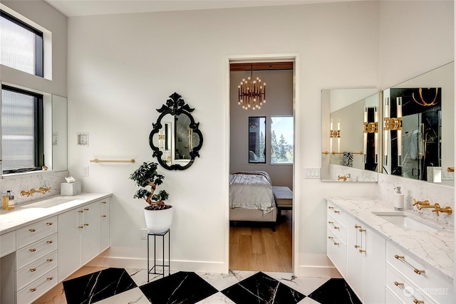 bathroom with an inviting chandelier and vanity