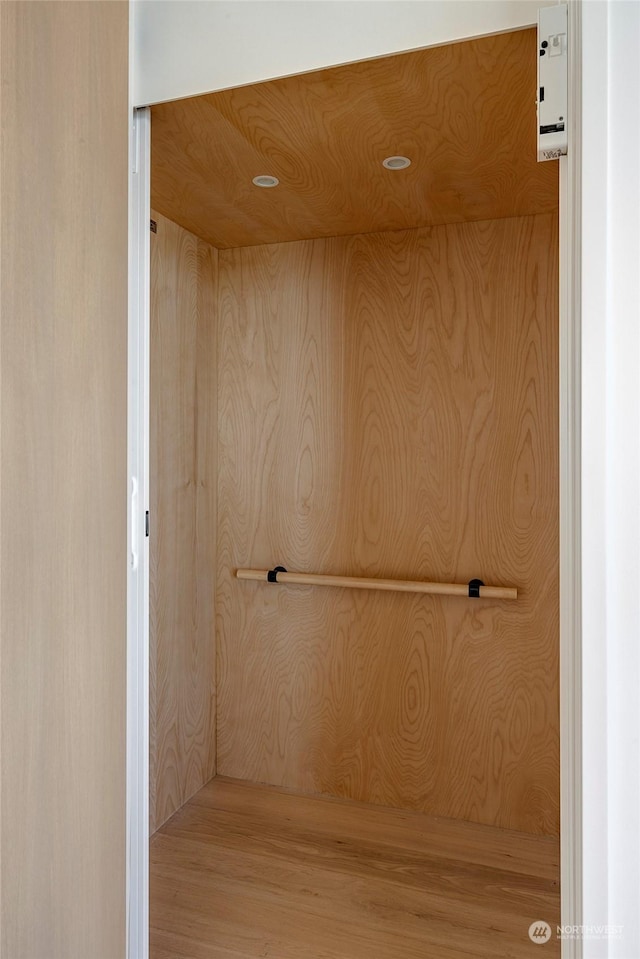 bathroom featuring wooden walls and elevator