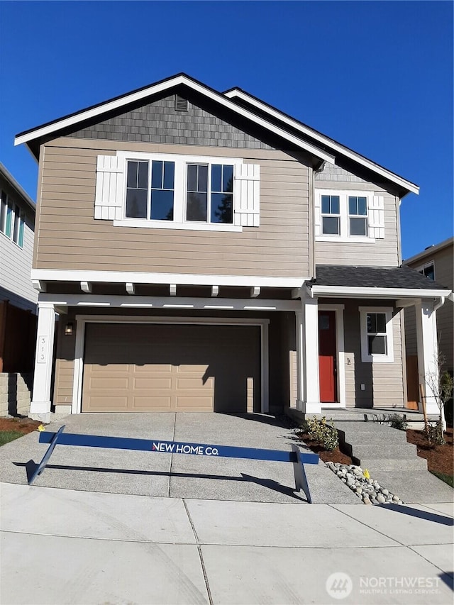 view of front facade featuring driveway and an attached garage