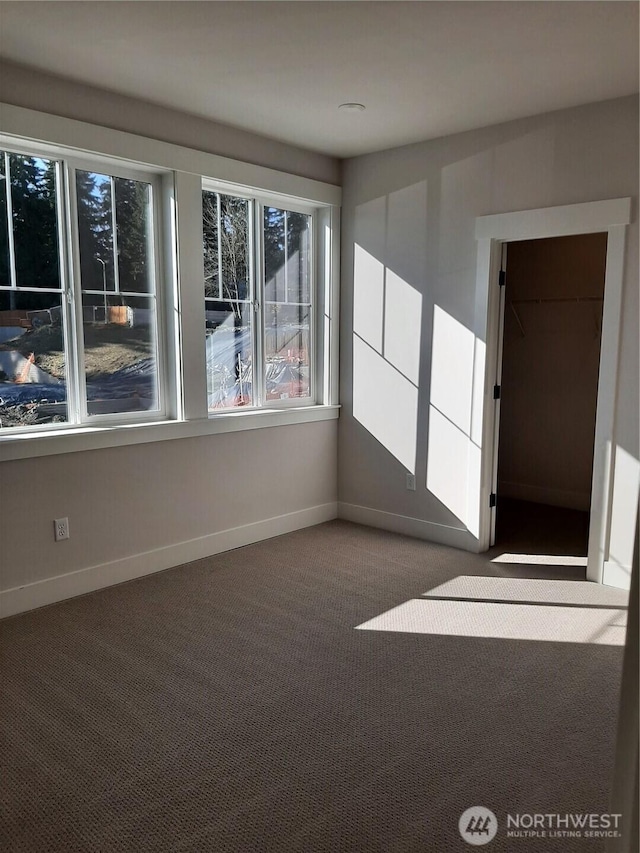 spare room with carpet flooring and baseboards