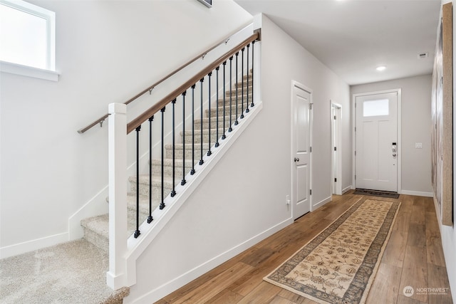 foyer featuring hardwood / wood-style flooring and a healthy amount of sunlight