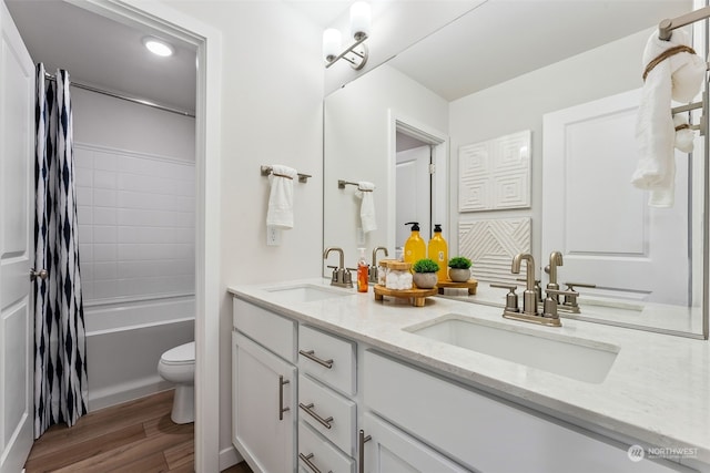 full bathroom with vanity, hardwood / wood-style floors, toilet, and shower / bath combo with shower curtain