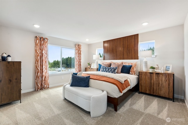 bedroom featuring radiator and light colored carpet