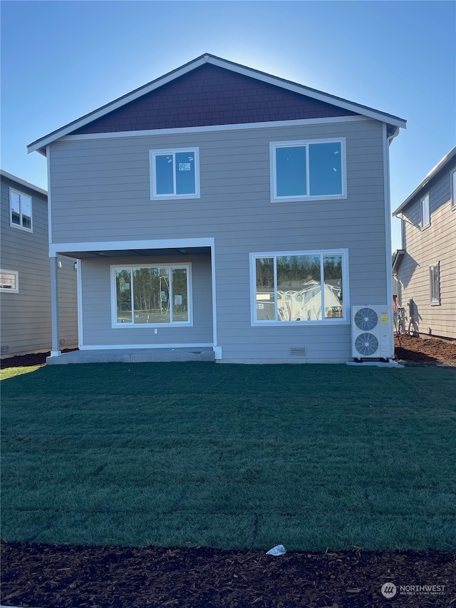 rear view of house with a lawn and ac unit