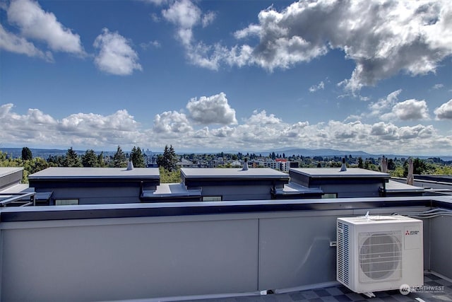 view of patio with a mountain view, ac unit, and a balcony