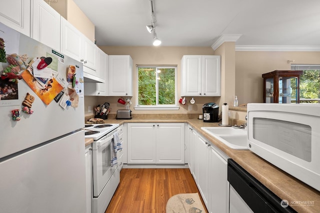 kitchen featuring sink, crown molding, white appliances, light hardwood / wood-style floors, and white cabinets