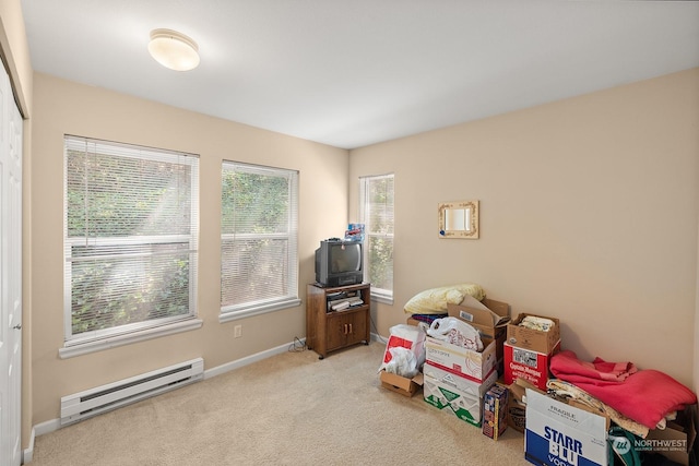 miscellaneous room with light colored carpet and baseboard heating