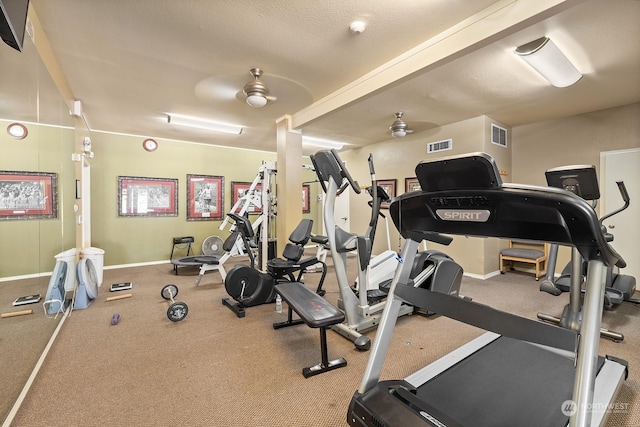 exercise room with a textured ceiling and ceiling fan