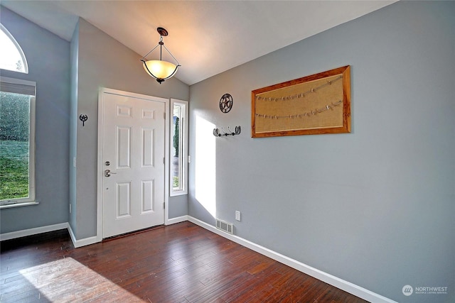 foyer entrance featuring lofted ceiling and dark hardwood / wood-style flooring