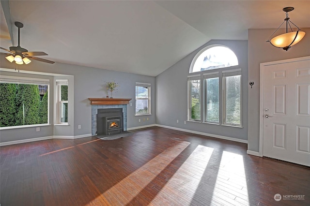 unfurnished living room with ceiling fan, vaulted ceiling, dark hardwood / wood-style floors, and a healthy amount of sunlight