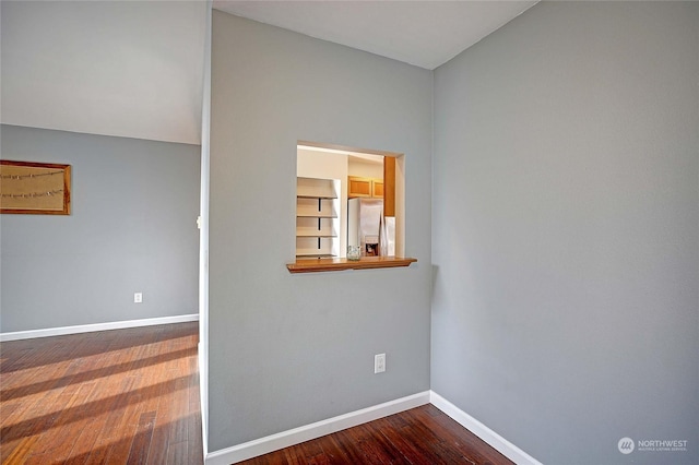 spare room with hardwood / wood-style floors