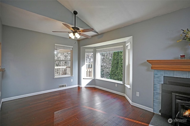 unfurnished living room with ceiling fan, dark hardwood / wood-style flooring, vaulted ceiling, and a fireplace