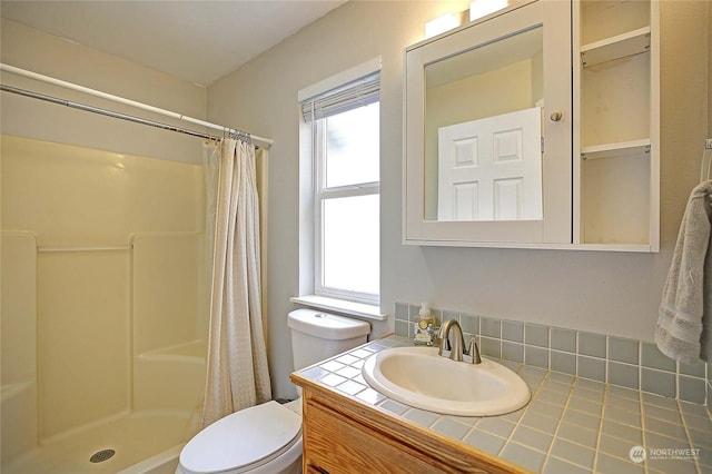 bathroom featuring vanity, curtained shower, and toilet