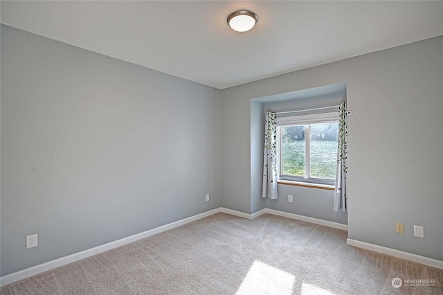 unfurnished room featuring light carpet