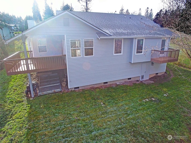 back of house featuring a deck and a lawn