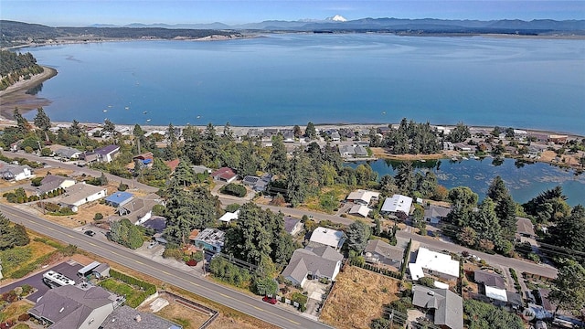 aerial view featuring a water and mountain view