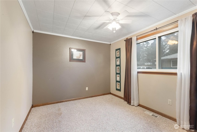 unfurnished room featuring ceiling fan, light colored carpet, and ornamental molding