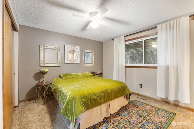 bedroom with a textured ceiling, ceiling fan, and a closet