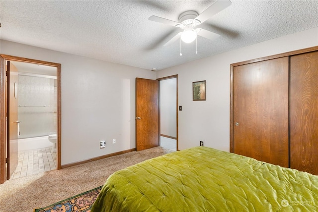 bedroom featuring light colored carpet, a textured ceiling, ceiling fan, and a closet