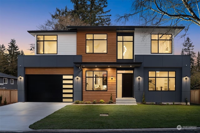 modern home with a garage and a lawn