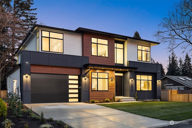 modern home with a garage and a lawn