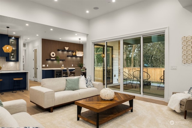 living room featuring light hardwood / wood-style floors and a towering ceiling