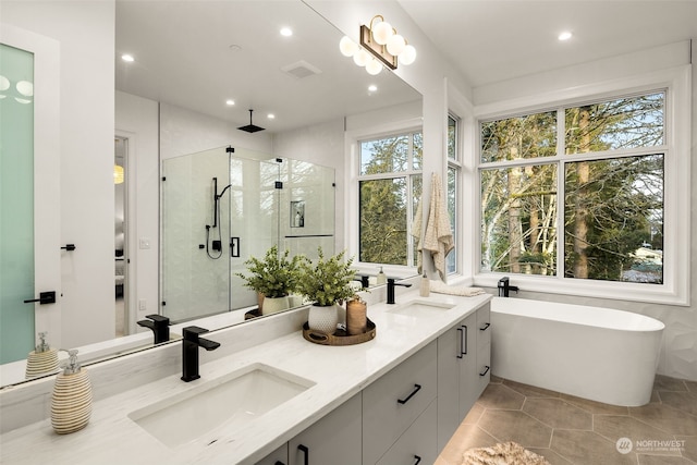 bathroom featuring vanity, tile patterned floors, and shower with separate bathtub