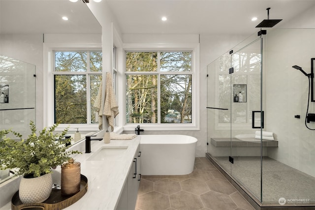 bathroom with tile patterned floors, vanity, and independent shower and bath