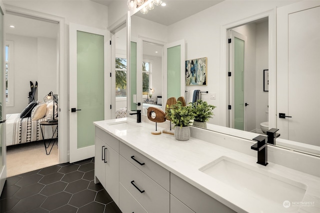 bathroom with vanity, toilet, and tile patterned flooring