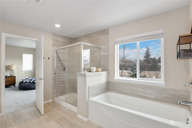 bathroom with shower with separate bathtub